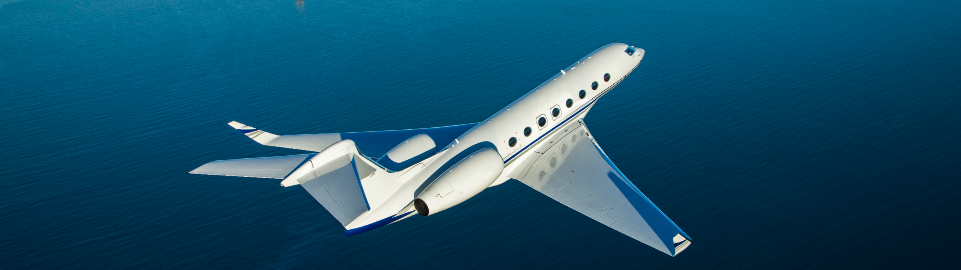 Gulfstream 450 private jet with winglets flying over the Pacific Ocean