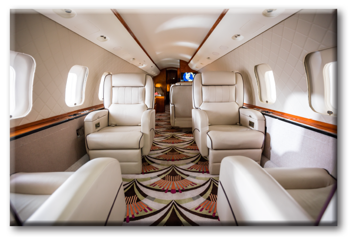 Interior view of a Global Express private Jet. Art Deco style with leather captain chairs, carpet in red, green and black patterns and textured walls.
